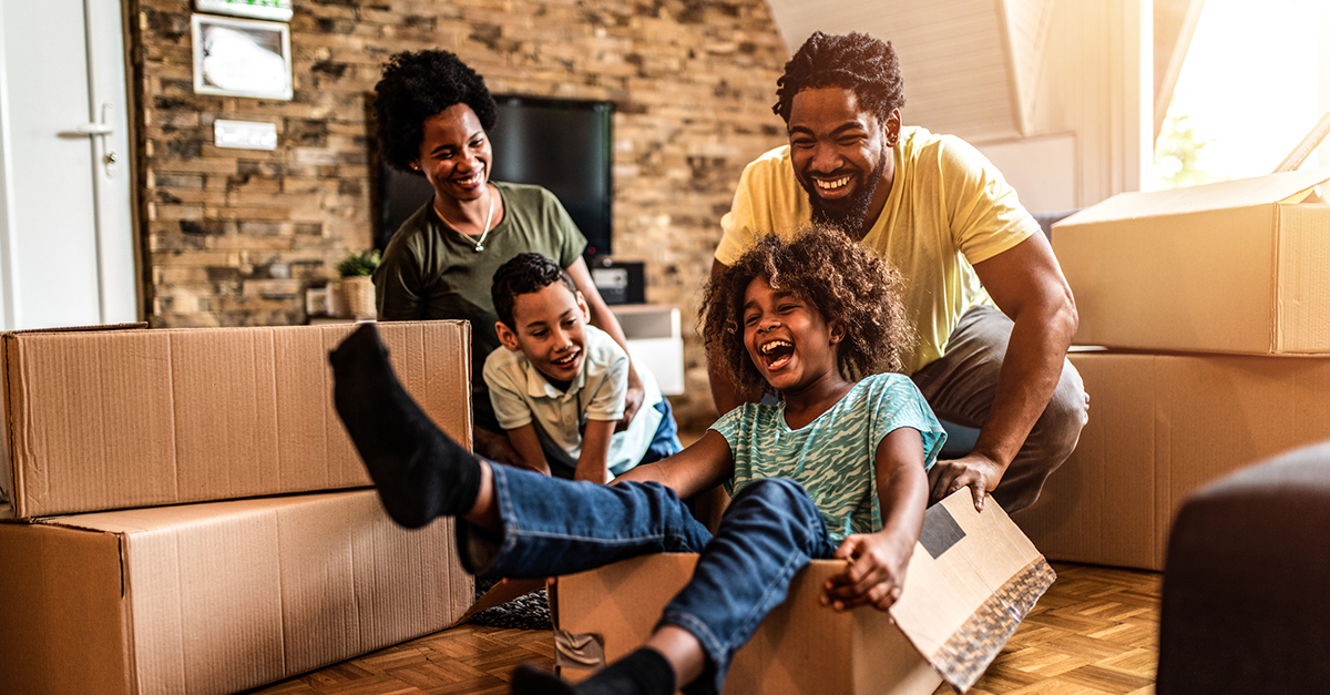 A family of four playing in their new living room