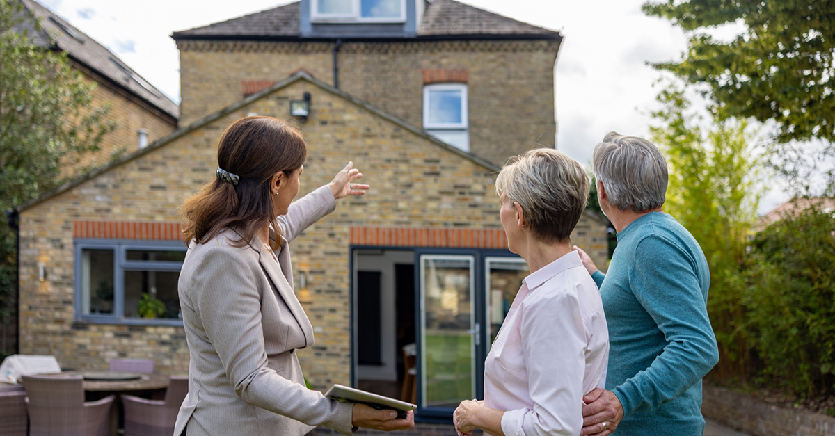 An older couple tours a home with an agent